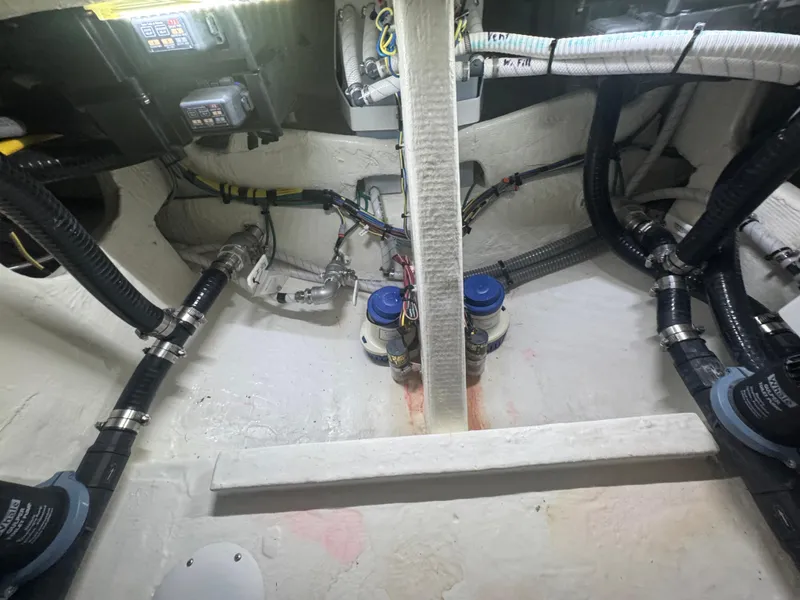 Slide: The Image of Engine compartment of 2023 Fountain 38 SC boat with visible wiring and components. - 34