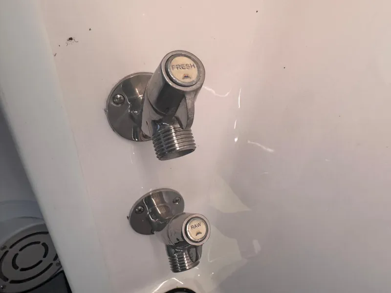 Slide: The Image of Boat water connectors labeled "Fresh" and "Raw" on a 2023 Fountain 38 SC. - 36