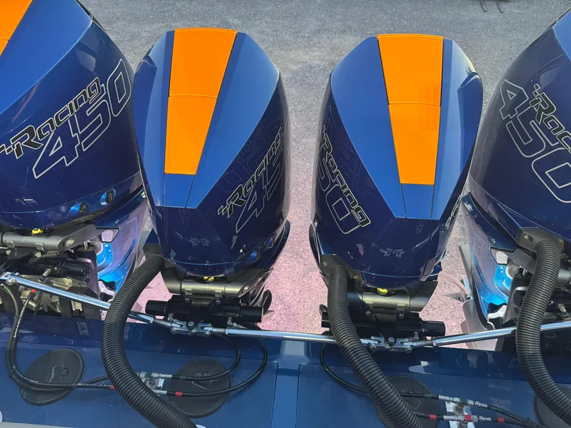 Slide: The Image of Four blue and orange Racing 450 outboard motors on a 2023 Fountain 38 SC boat. - 38