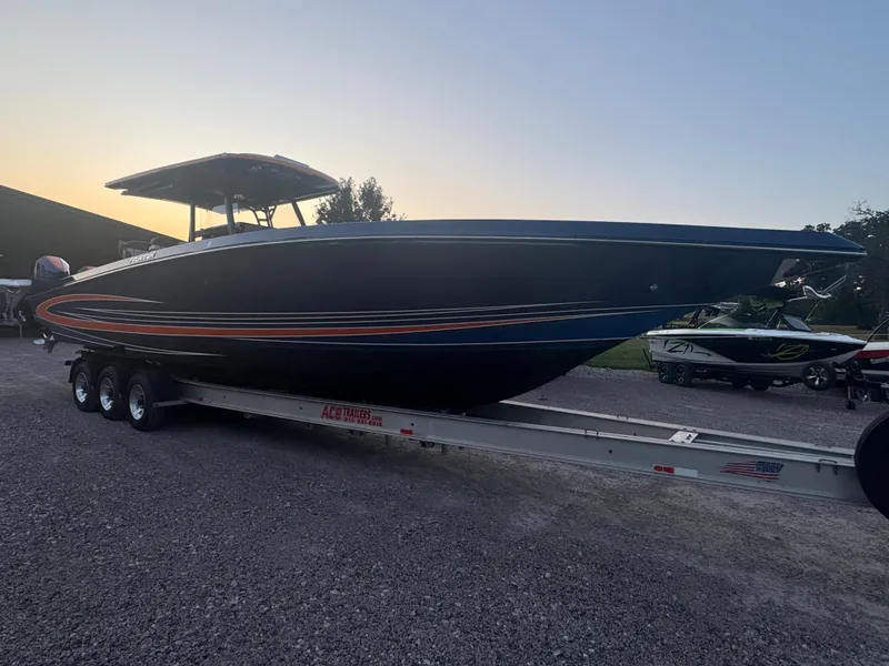 Slide: The Image of 2023 Fountain 38 SC boat on trailer at sunset, side view. - 4