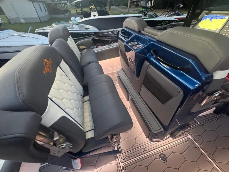 Slide: The Image of 2023 Fountain 38 SC boat interior with luxurious seating and modern dashboard. - 40