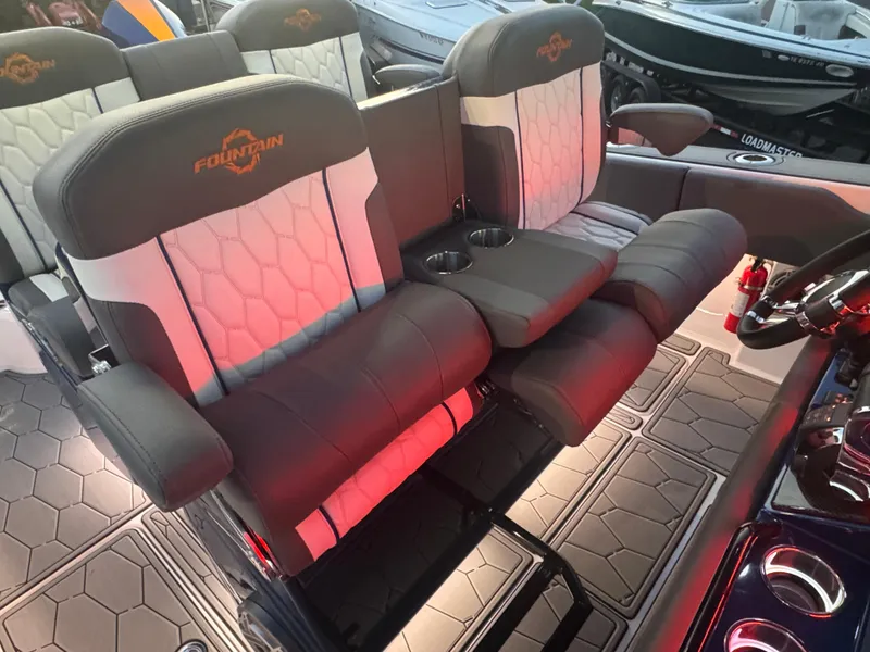 Slide: The Image of 2023 Fountain 38 SC boat interior with luxurious seating and cup holders. - 48