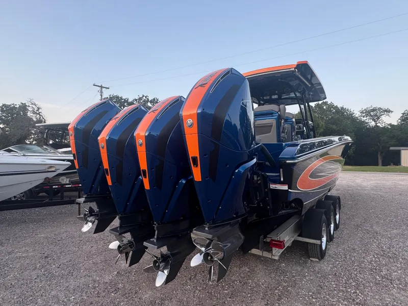 Slide: The Image of 2023 Fountain 38 SC boat with triple outboard engines on a trailer. - 7