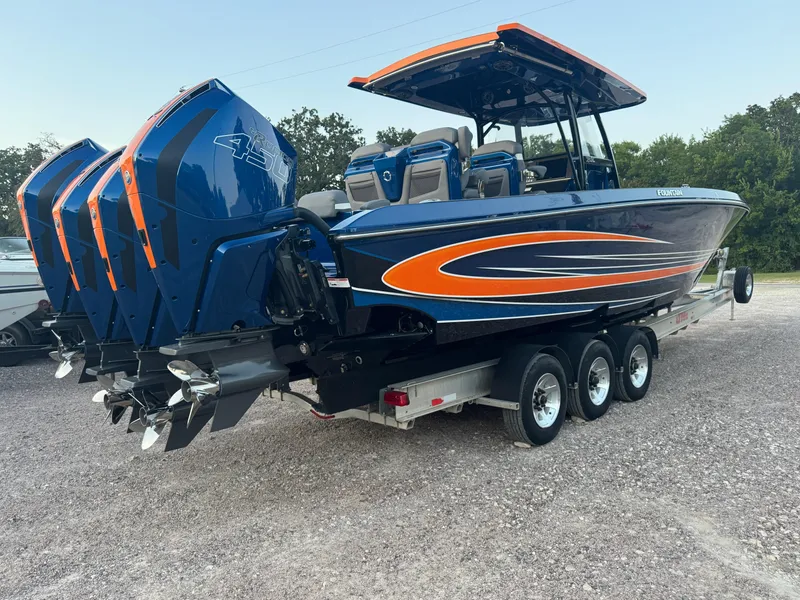 Slide: The Image of 2023 Fountain 38 SC boat with triple outboard engines on a trailer. - 8