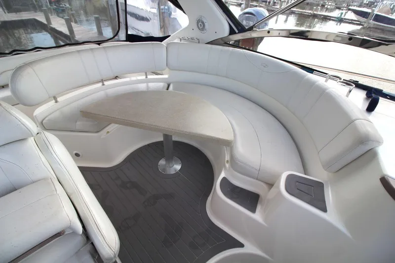 Slide: The Image of 2004 Regal Commodore 3860 yacht interior with curved seating and table. - 10