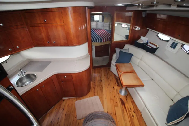 Slide: The Image of Luxurious interior of 2004 Regal Commodore 3860 yacht with wood cabinetry and plush seating. - 13