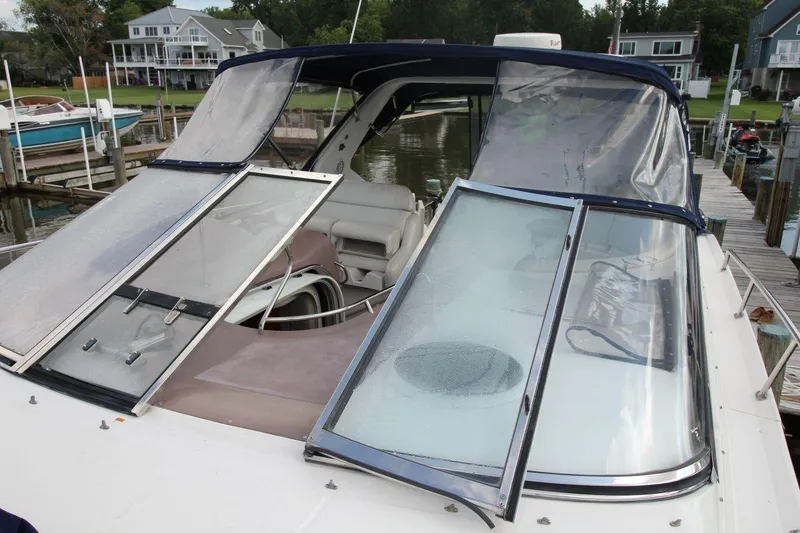 Slide: The Image of 2004 Regal Commodore 3860 yacht docked, featuring open windshield and covered seating area. - 7