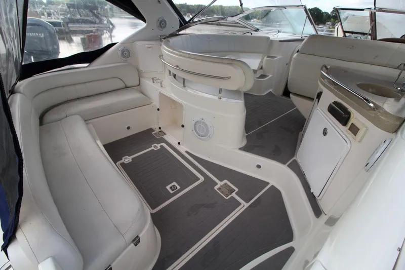 Slide: The Image of 2004 Regal Commodore 3860 yacht interior with white seating and sleek design. - 8