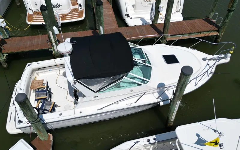 Slide: The Image of 2001 Tiara Yachts 2900 Open docked, aerial view, black canopy, white deck. - 0