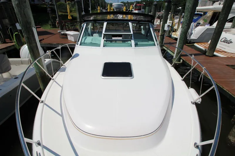 Slide: The Image of 2001 Tiara Yachts 2900 Open docked, showcasing sleek design and spacious deck. - 10