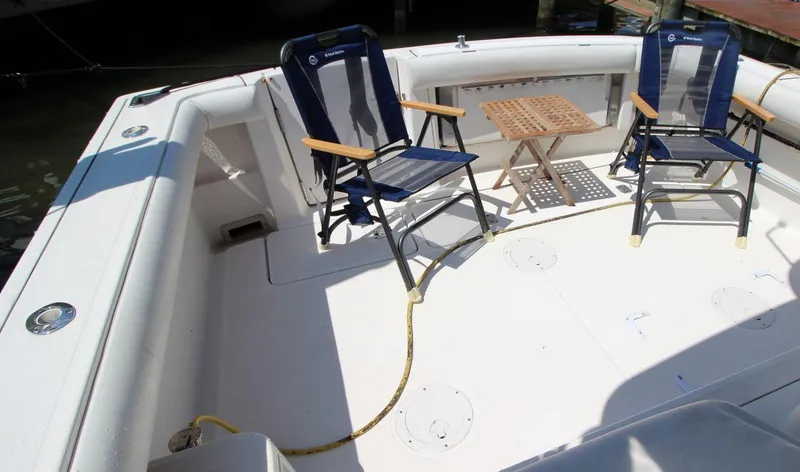 Slide: The Image of 2001 Tiara Yachts 2900 Open deck with chairs and table, ideal for relaxation. - 11