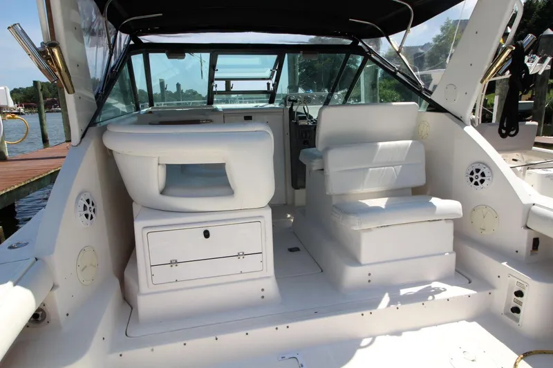 Slide: The Image of 2001 Tiara Yachts 2900 Open cockpit with white seating and helm, dockside view. - 12