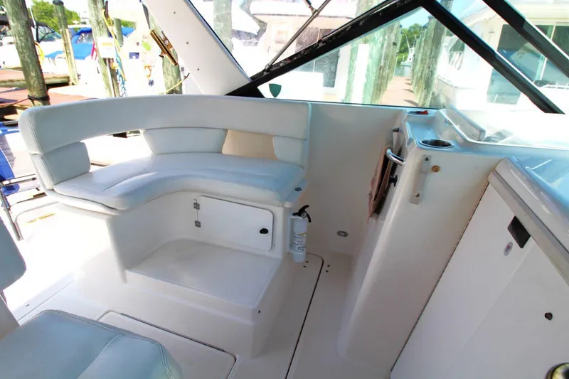 Slide: The Image of 2001 Tiara Yachts 2900 Open interior with white seating and storage compartments. - 13