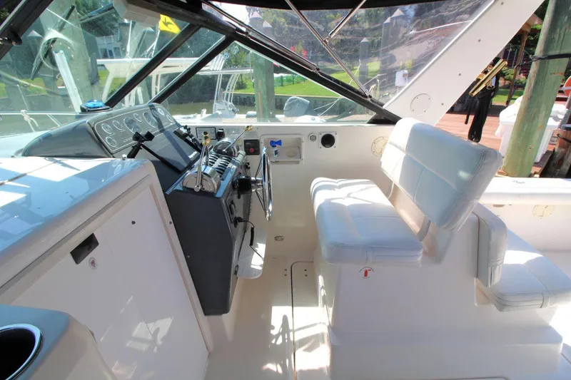 Slide: The Image of 2001 Tiara Yachts 2900 Open cockpit with steering wheel and white seating. - 14