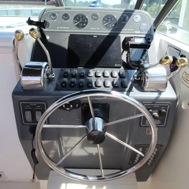 Slide: The Image of 2001 Tiara Yachts 2900 Open helm with steering wheel and control panel. - 15
