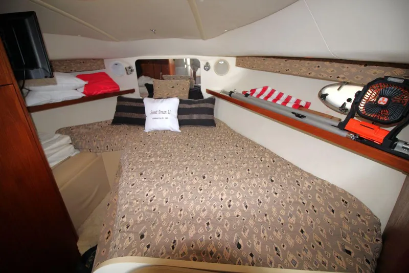 Slide: The Image of Cozy cabin interior of 2001 Tiara Yachts 2900 Open with patterned bedding and nautical decor. - 19