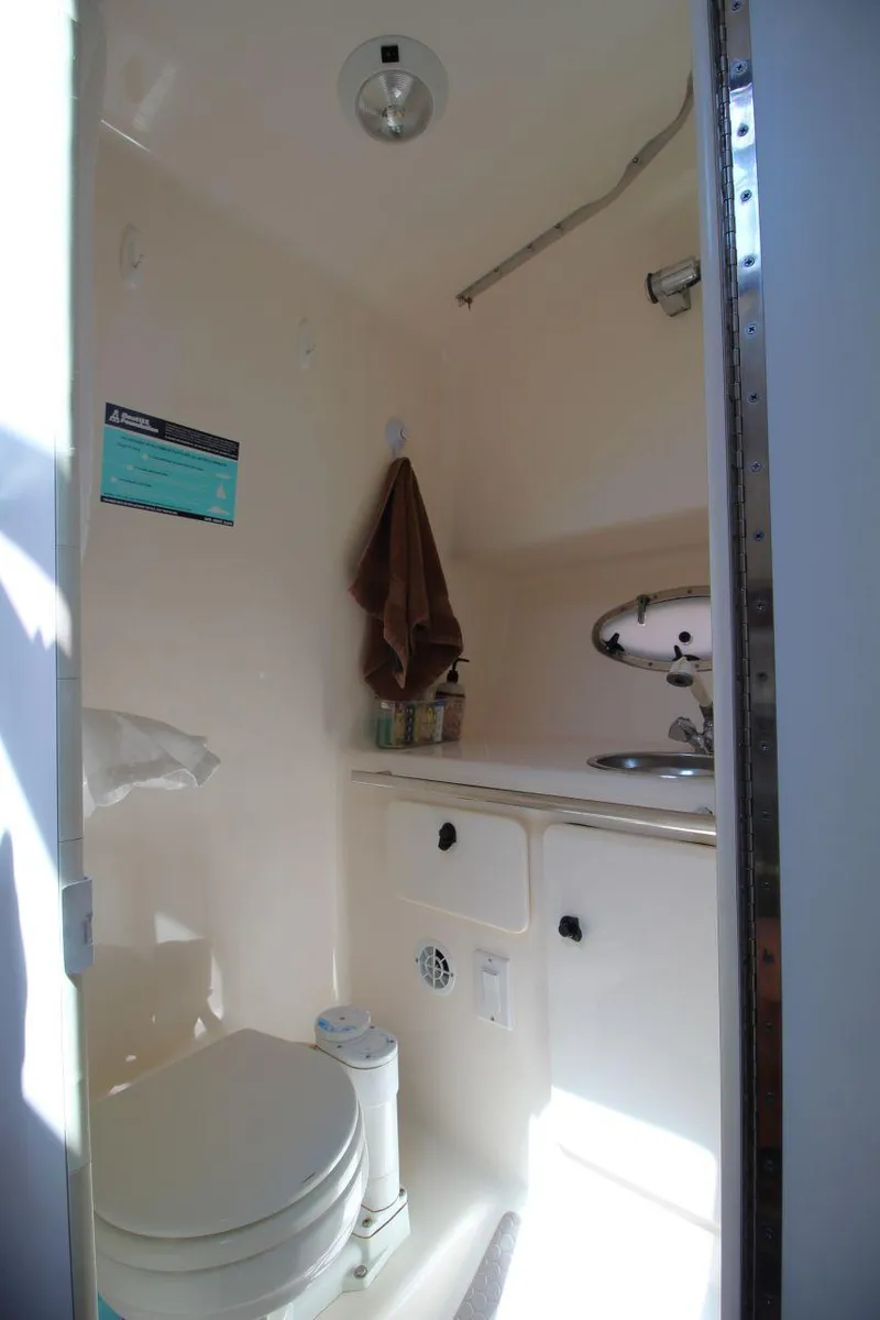 Slide: The Image of 2001 Tiara Yachts 2900 Open bathroom with toilet, sink, and storage. - 20