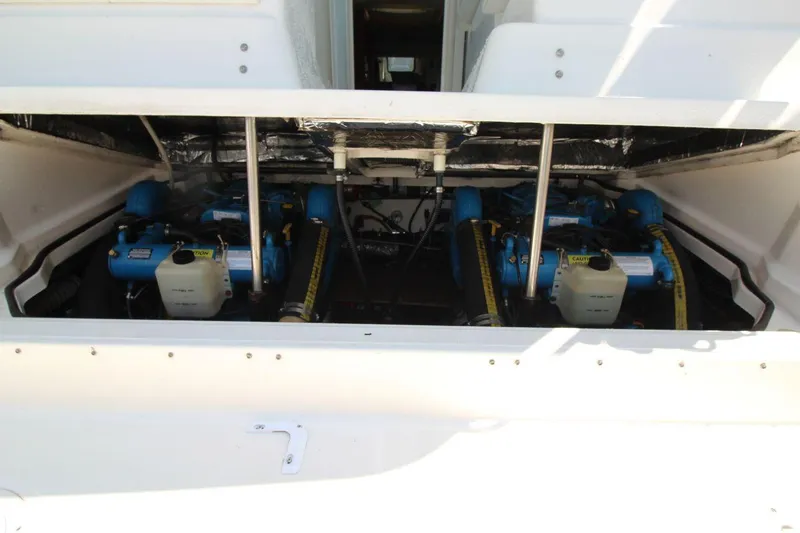 Slide: The Image of Engine compartment of 2001 Tiara Yachts 2900 Open, showcasing dual blue engines. - 21