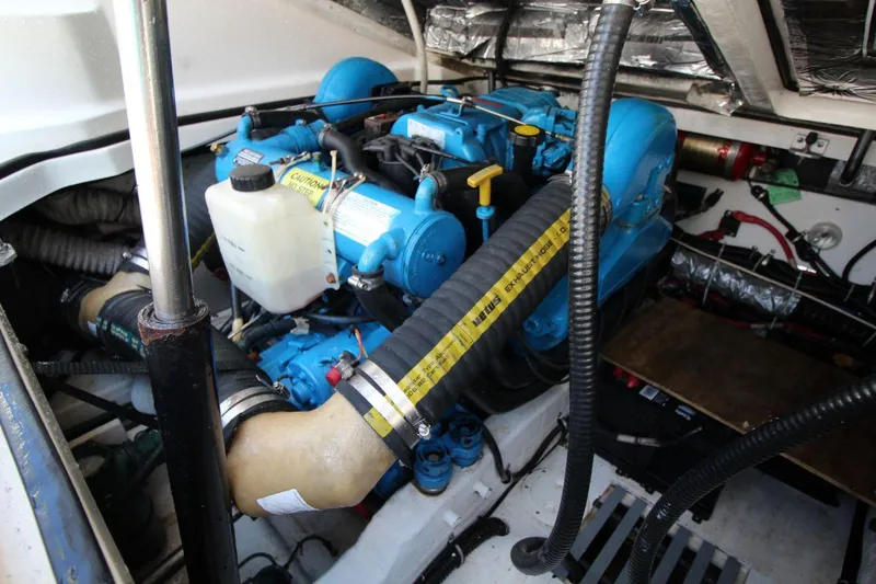 Slide: The Image of Engine compartment of a 2001 Tiara Yachts 2900 Open, featuring blue engine components. - 22