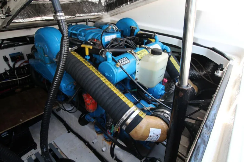 Slide: The Image of Engine compartment of 2001 Tiara Yachts 2900 Open, showcasing blue engine and components. - 23