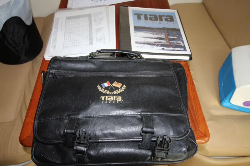 Slide: The Image of Black Tiara Yachts bag on table with documents and brochure, 2001 Tiara 2900 Open. - 24