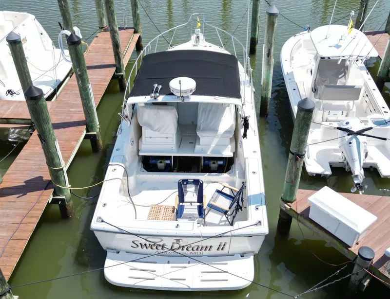 Slide: The Image of 2001 Tiara Yachts 2900 Open docked, aerial view, with black canopy and seating area. - 3