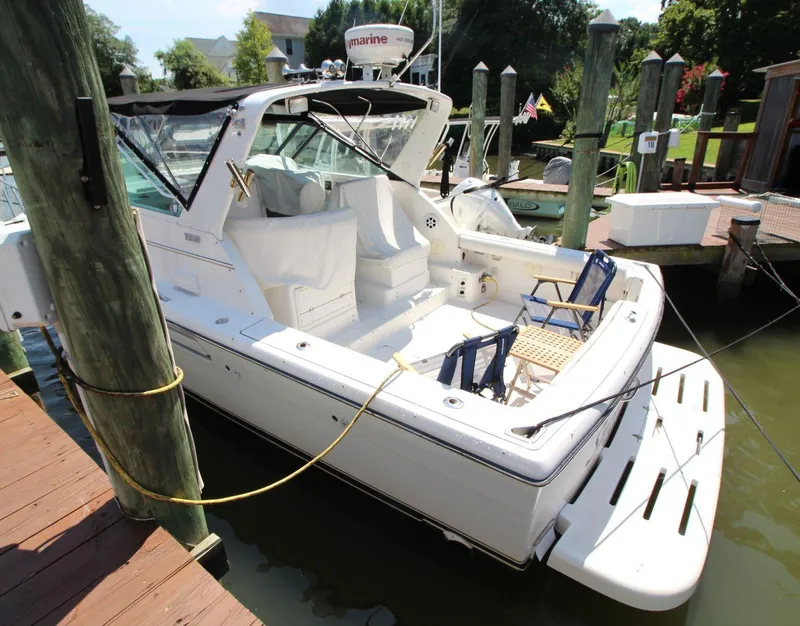 Slide: The Image of 2001 Tiara Yachts 2900 Open docked, featuring spacious seating and sleek design. - 7