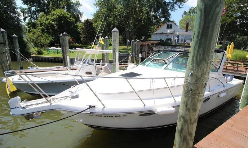 Slide: The Image of 2001 Tiara Yachts 2900 Open docked, showcasing sleek design and spacious deck. - 8