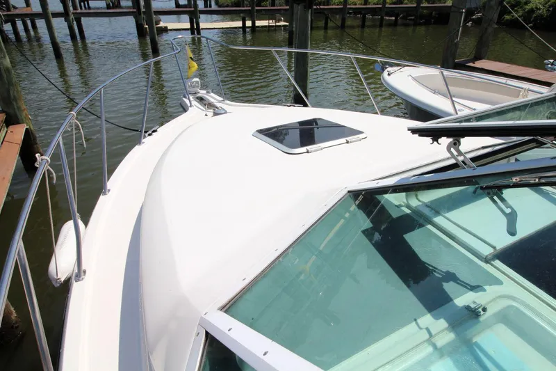 Slide: The Image of 2001 Tiara Yachts 2900 Open boat docked, showcasing bow and windshield. - 9
