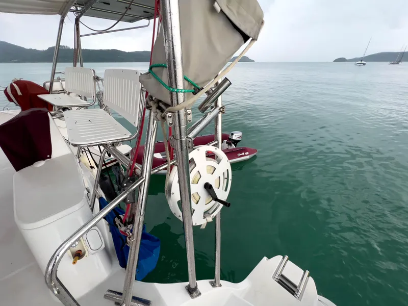 Slide: The Image of Sailboat deck view of Antares PDQ 44, 2005 model, overlooking calm sea and distant islands. - 11