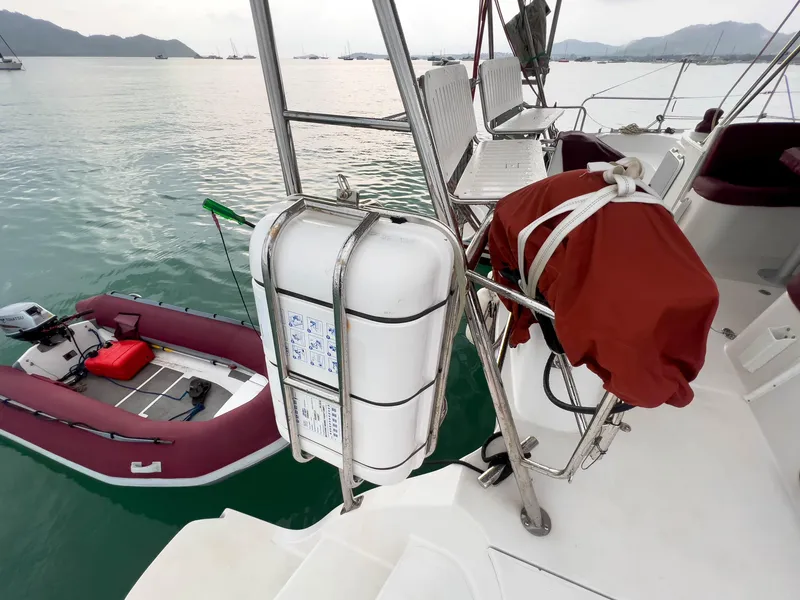 Slide: The Image of Sailboat deck with life raft and dinghy, Antares PDQ 44, 2005 model, on calm water. - 12