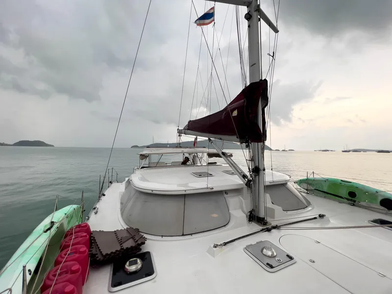 Slide: The Image of Sailing yacht Antares PDQ 44, 2005 model, on calm waters under cloudy skies. - 2