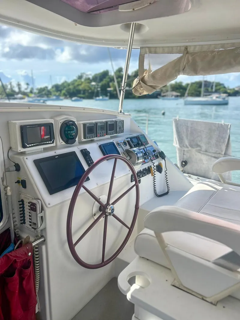 Slide: The Image of 2005 Antares PDQ 44 yacht helm with scenic marina view. - 20