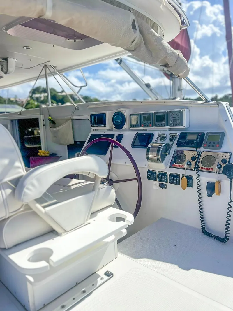 Slide: The Image of 2005 Antares PDQ 44 yacht cockpit with navigation instruments and white seating. - 21