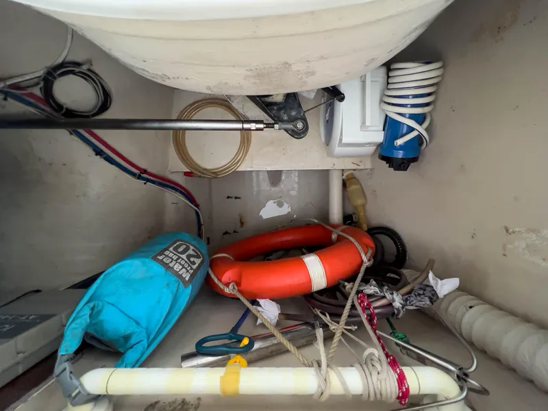Slide: The Image of Storage compartment with life preserver, ropes, and equipment on a 2005 Antares PDQ 44 boat. - 22