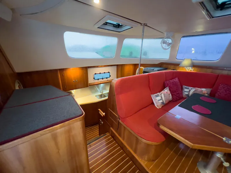 Slide: The Image of Interior of 2005 Antares PDQ 44 yacht with red seating and wooden finishes. - 29