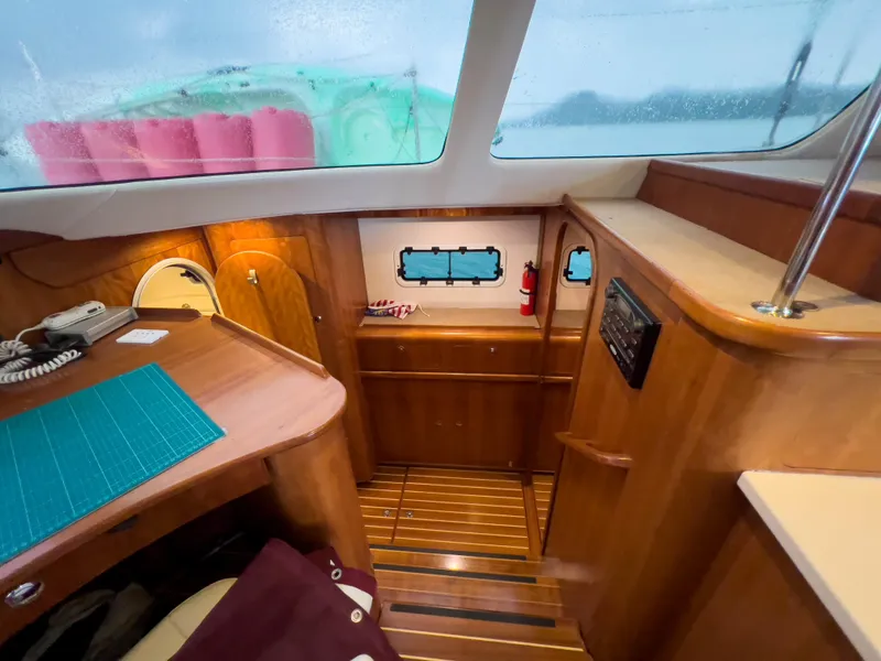 Slide: The Image of Interior of 2005 Antares PDQ 44 yacht with wooden finish and navigation area. - 34