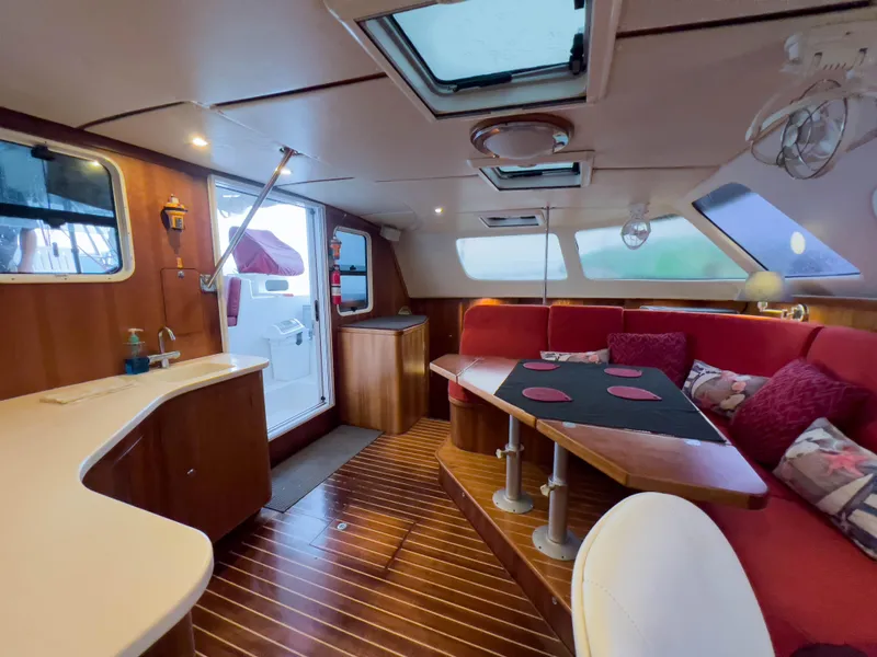 Slide: The Image of Luxurious interior of 2005 Antares PDQ 44 yacht with red seating and wooden finishes. - 36