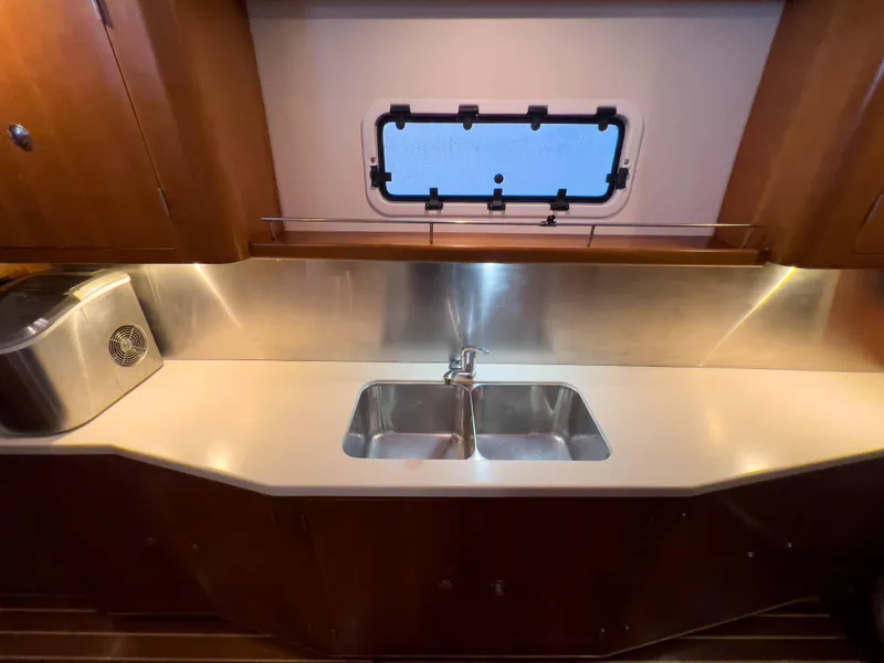 Slide: The Image of 2005 Antares PDQ 44 yacht kitchen with stainless steel sink and window view. - 38
