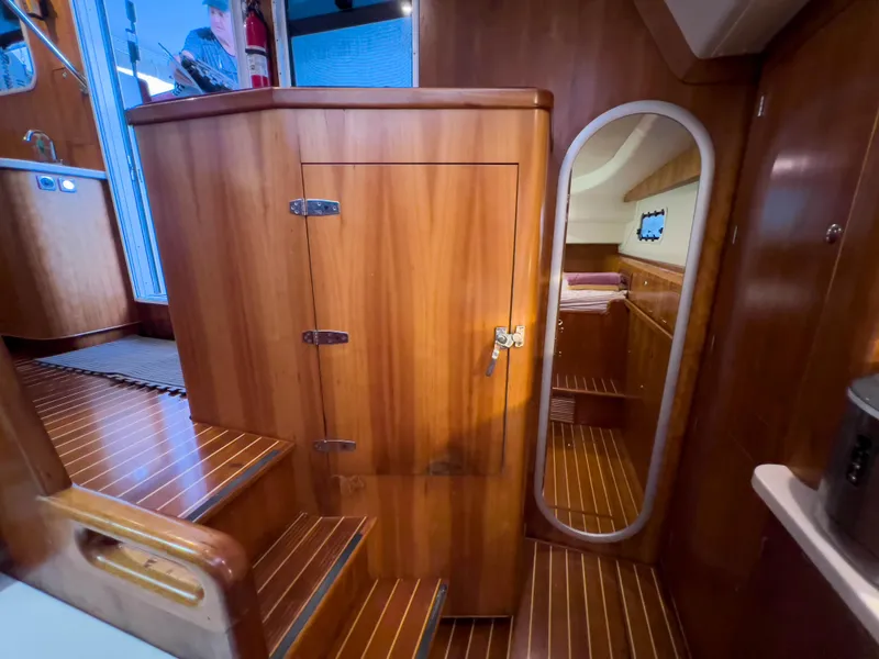 Slide: The Image of Interior of 2005 Antares PDQ 44 yacht with wooden cabinetry and mirror. - 46