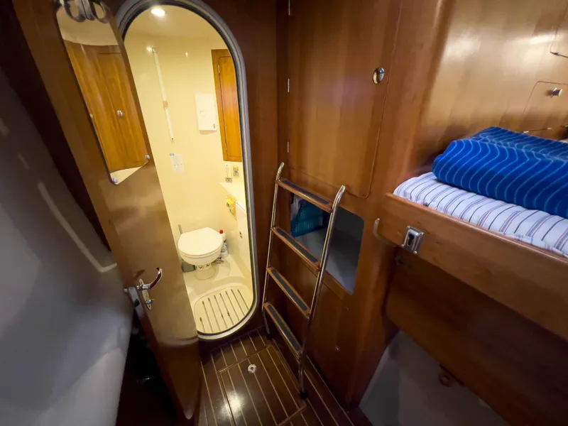 Slide: The Image of Interior of 2005 Antares PDQ 44 yacht showing cabin with bunk bed and bathroom. - 49