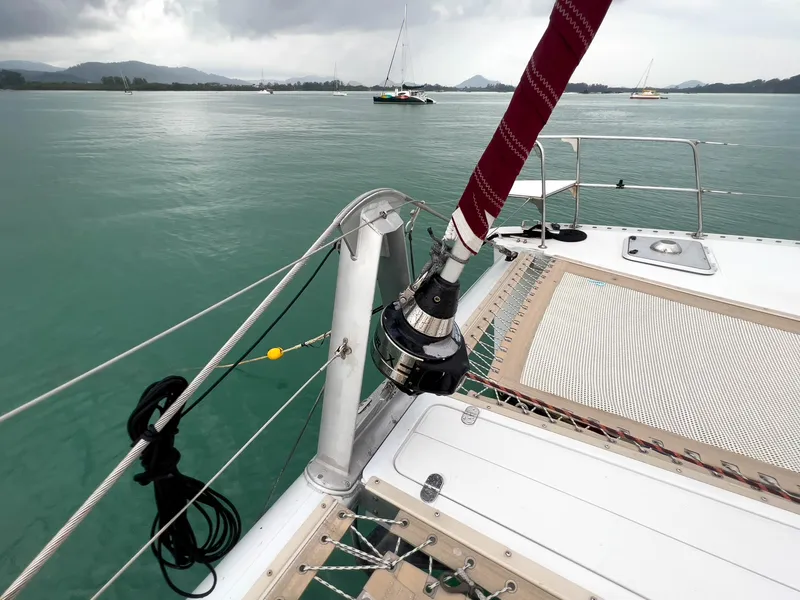 Slide: The Image of Sailing on Antares PDQ 44 catamaran, 2005 model, in calm waters with distant sailboats. - 5