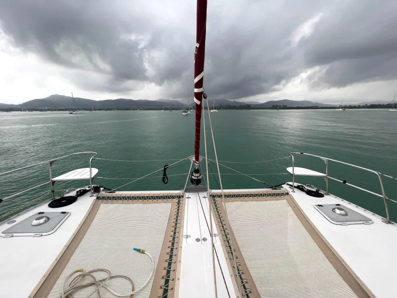 Slide: The Image of Catamaran deck view on cloudy day, Antares PDQ 44, 2005 model, sailing on calm waters. - 6