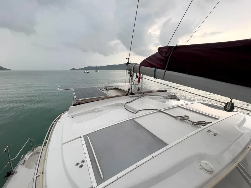 Slide: The Image of Sailing yacht Antares PDQ 44, 2005 model, on calm waters under cloudy skies. - 9