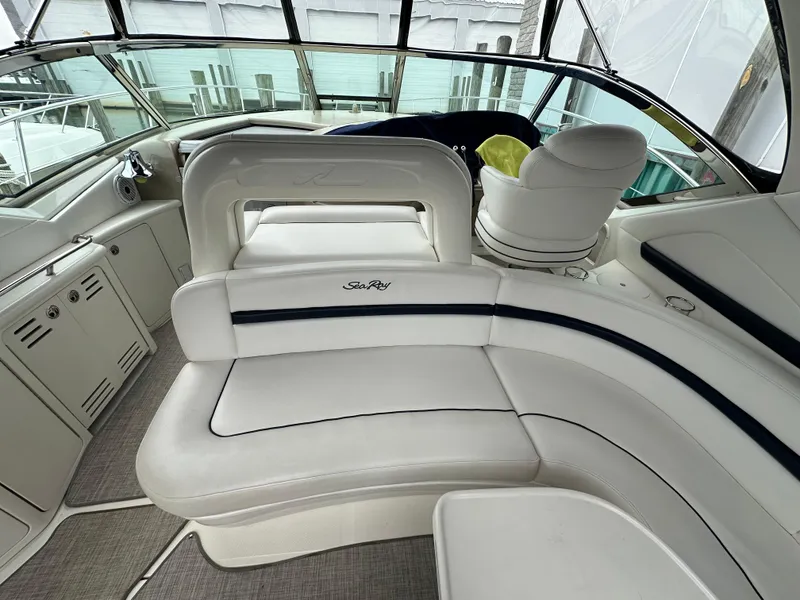 Slide: The Image of Interior of 2003 Sea Ray 420 Sundancer yacht with white leather seating and helm. - 10