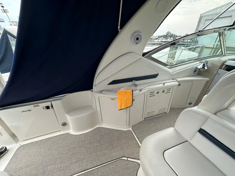 Slide: The Image of 2003 Sea Ray 420 Sundancer interior with seating and storage, featuring a sleek design. - 11