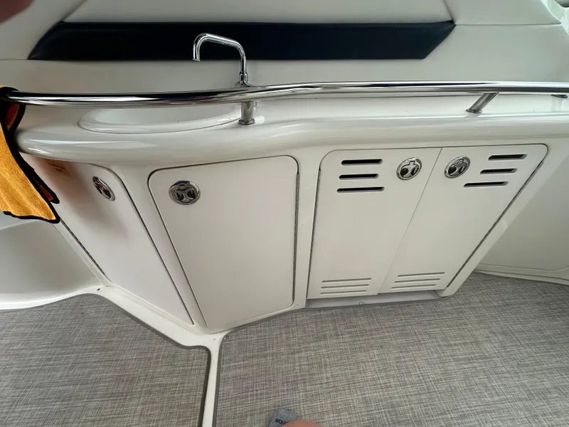 Slide: The Image of 2003 Sea Ray 420 Sundancer interior with sink and storage cabinets. - 15