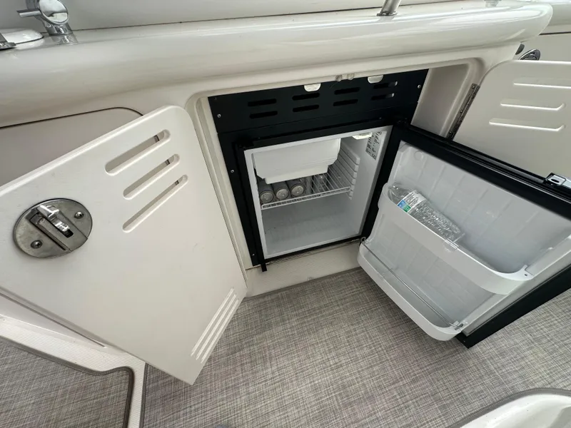 Slide: The Image of Mini fridge on 2003 Sea Ray 420 Sundancer yacht, open with drinks inside. - 16