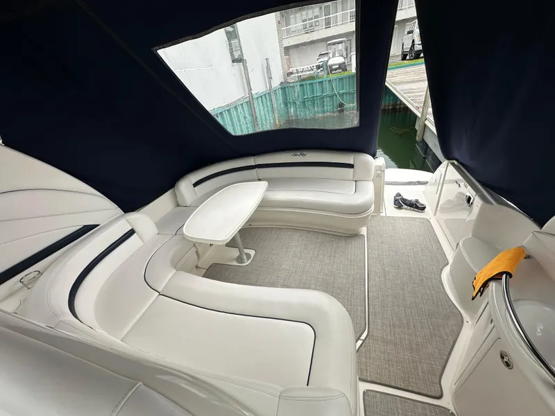 Slide: The Image of Interior of 2003 Sea Ray 420 Sundancer yacht with white seating and table. - 17