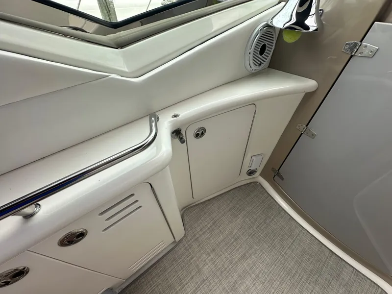 Slide: The Image of 2003 Sea Ray 420 Sundancer interior with storage compartments and speaker. - 19